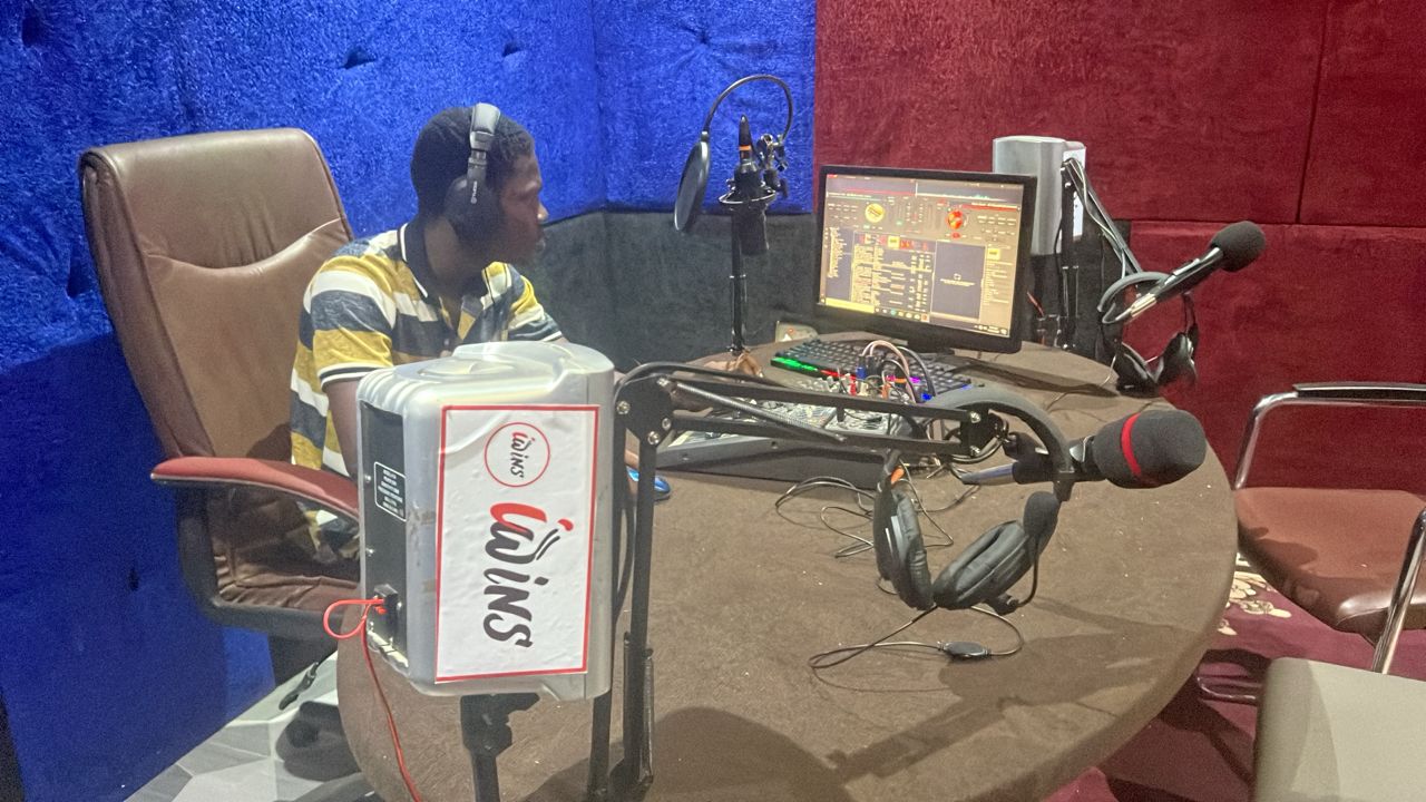 Presenter on air in the Iwins Radio studio