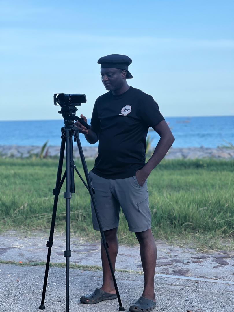 Iwins Media School tutor filming by the Prampram coast